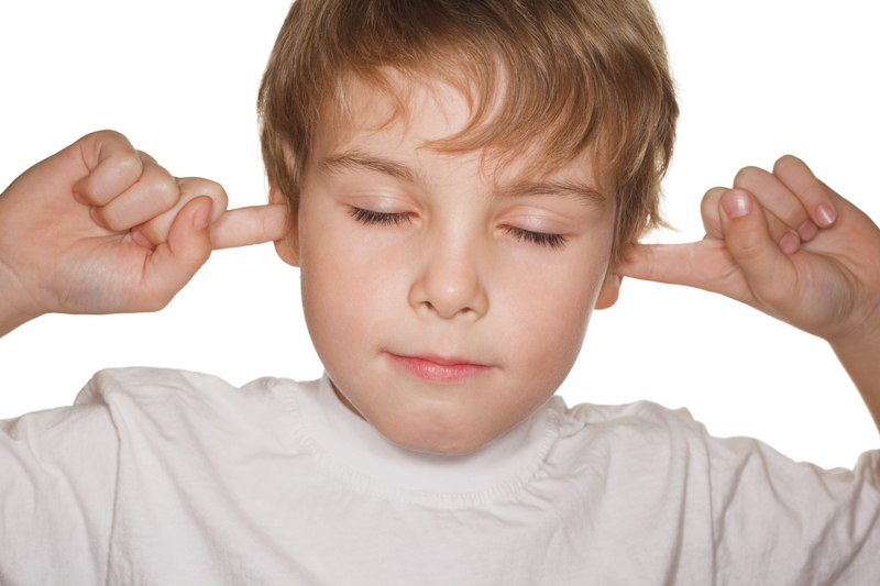Child with fingers in ears